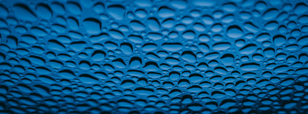 Water drops on blue background. Water drops texture. Close up.