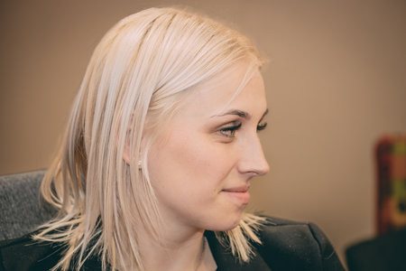 Portrait of a beautiful woman with blond hair in a beauty salonの写真素材