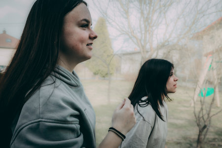 Two beautiful young women talking in the park. Close-up.の写真素材