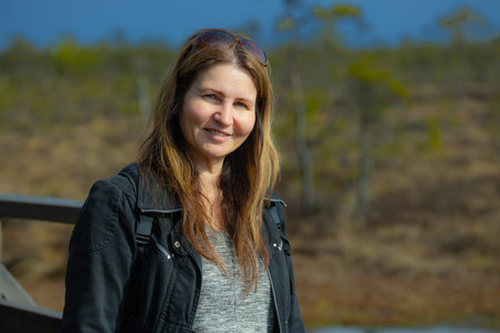 Portrait of a middle-aged woman with long hair in the countryside.の写真素材
