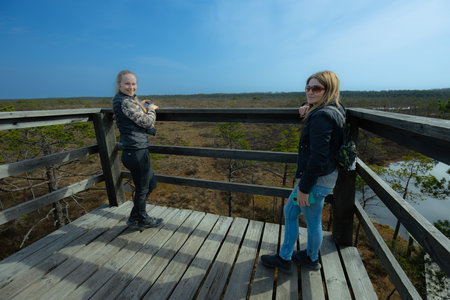 Mother and daughter on a boardwalk in Everglades National Park, swamp woman rested on the lookout towerの写真素材