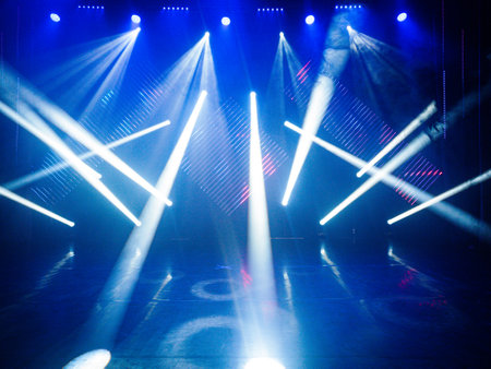 stage lighting effect in the dark with rays of light and smoke from the stageの写真素材