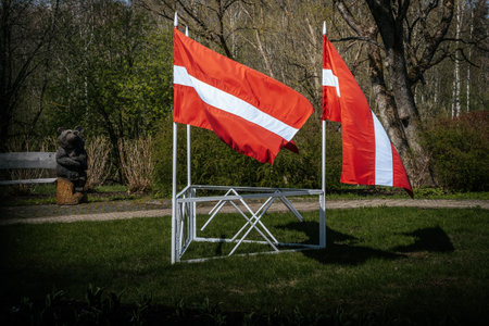 Flag of Latvian and Latvia on a white fence in the park.の写真素材