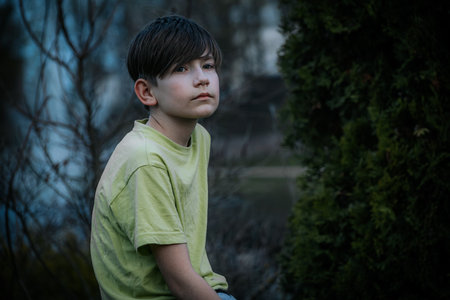 portrait of a boy in a green T-shirt in the parkの写真素材