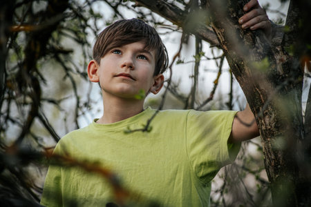 Portrait of a boy in a green T-shirt on the natureの写真素材