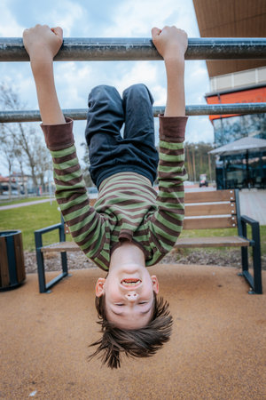 Boy having fun on the playground. Concept of healthy lifestyle and sports