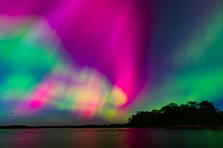 Aurora borealis, northern lights over the lake at nightの写真素材