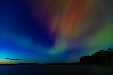Aurora borealis, northern lights over the lake at nightの写真素材