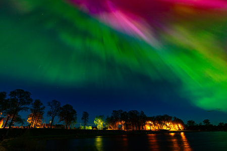 Aurora borealis, northern light, in the sky over the river.の写真素材