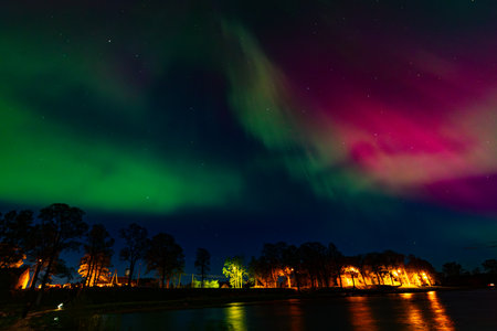 Aurora borealis, northern lights over the lake in the parkの写真素材