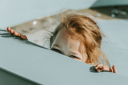 Portrait of a little girl on the edge of a swimming poolの写真素材