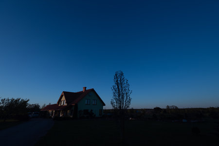 Lonely house with blue sky in the background at sunset.の写真素材