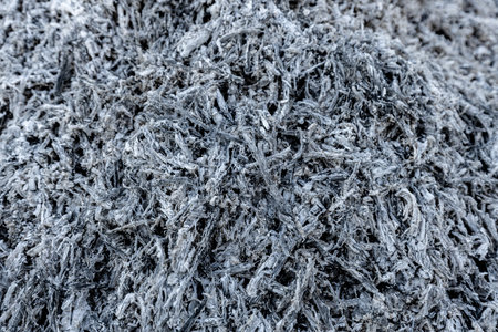 A close-up view of a pile of ashes, remnants of a fire, with intricate textures and tones, representing transformation and renewal.の写真素材