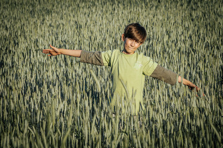 Young boy in a wheat field. Selective focus. Kid.の写真素材