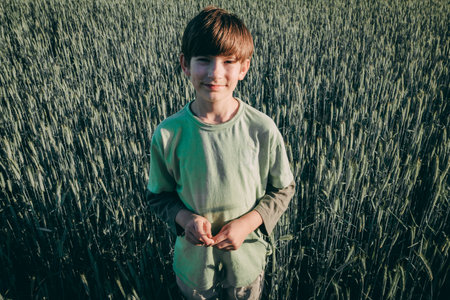 Portrait of a boy in a wheat field. Selective focus.の写真素材