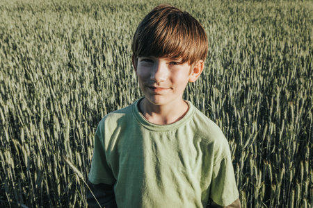 A portrait of a boy in a wheat field. Selective focus.の写真素材