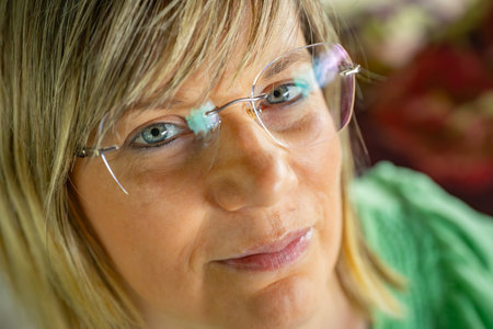 Portrait of a woman with eyeglasses looking at the cameraの写真素材