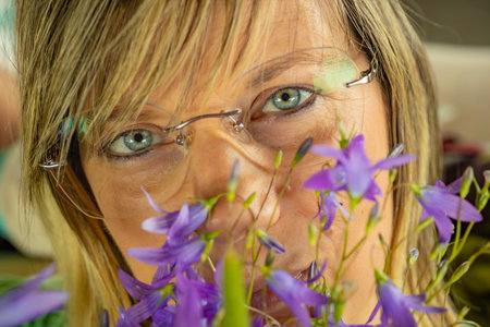 Close up portrait of a beautiful blond woman with bluebell flowers.の写真素材