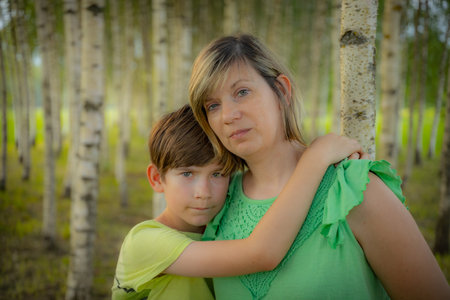 Portrait of a mother and her son in a birch groveの写真素材