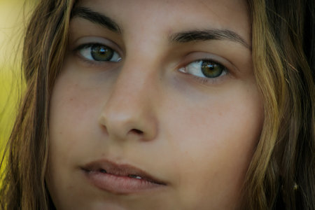 Close-up portrait of a beautiful young girl with green eyes.の写真素材