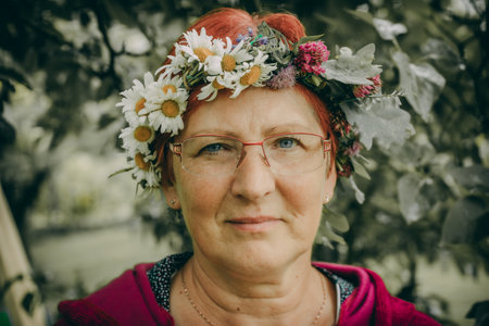 Mature woman with wreath of daisies on her headの写真素材