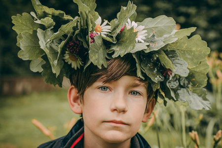 Boy with a wreath of daisies on his head.の写真素材