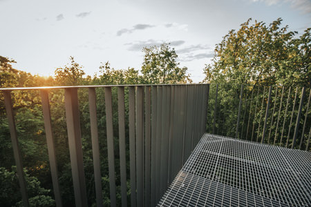 Steel metal fence in the park at sunset. Landscape. Nature.