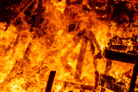 Fire flames with sparks on a black background, closeup of photo