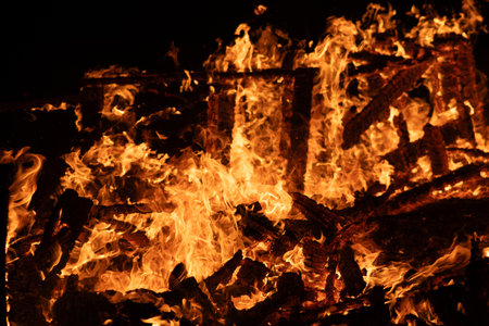 fire flames, burning campfire close up with sparks and firewoodの写真素材