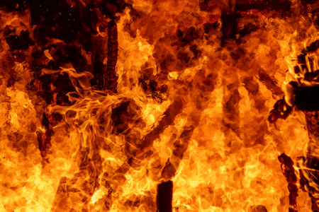 Fire burning in the night as a background, close-up.