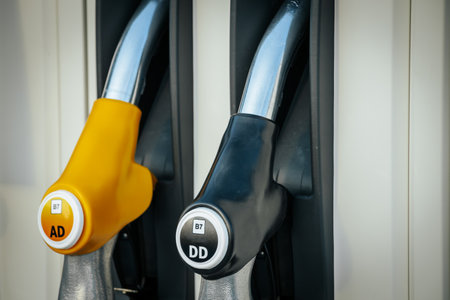 Close up fuel nozzle in gas station. Petrol or diesel filling station.の写真素材