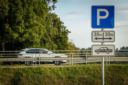 Parking sign on the road with cars in the background, Polandの写真素材