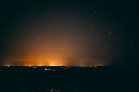 Night starry sky with many stars over the city. Night landscape.