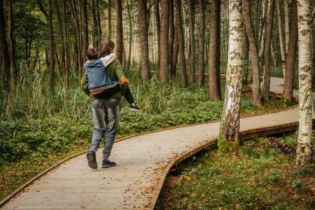 Couple walking in the forest. Man and woman spending time together.