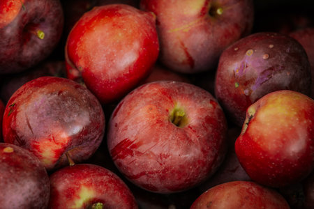 Ripe red plums on the counter of the store. Close-upの写真素材