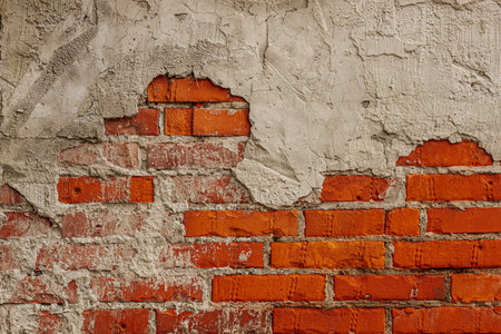 Red brick wall with a hole in it. Abstract background for design.の写真素材