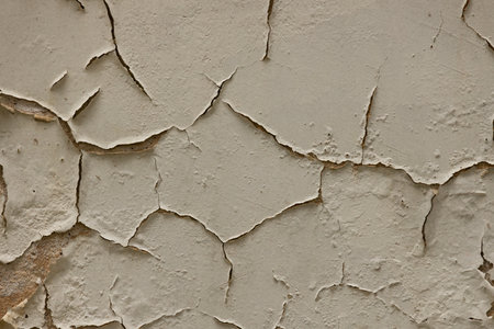 Texture of old wall with cracks and scratches which can be used as a backgroundの写真素材