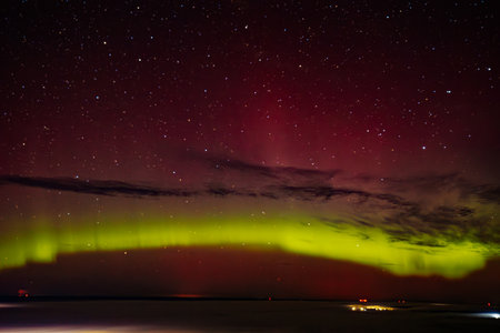Northern lights Aurora borealis in the night sky over the sea.の写真素材