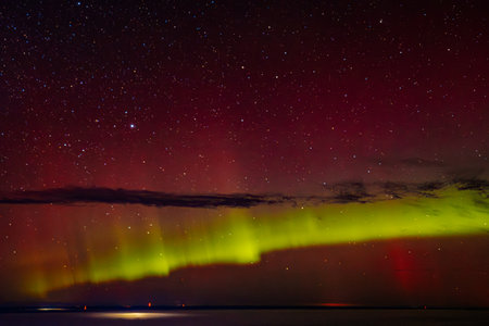 Aurora borealis, northern lights, over the sea at nightの写真素材