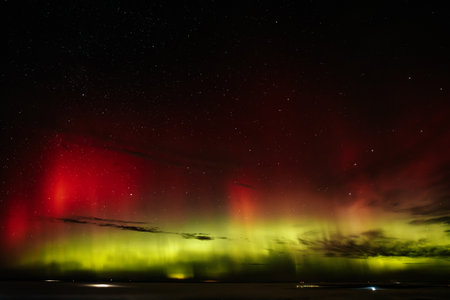 Aurora borealis, northern lights, over the sea.の写真素材