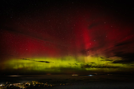 Aurora borealis northern lights in the night sky over the seaの写真素材