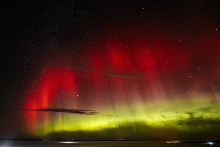 Aurora borealis, northern lights, over the sea.の写真素材