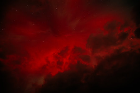 Dark night sky with clouds and stars.の写真素材