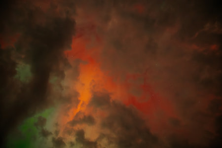 Fiery orange sky with clouds and stars. Abstract nature background.の写真素材