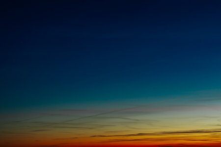 Sunset sky background with tiny clouds. Colorful sunset sky.の写真素材