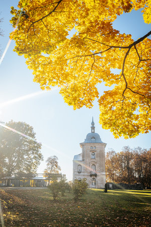 Autumn landscape with yellow maple trees and a church in the parkの写真素材