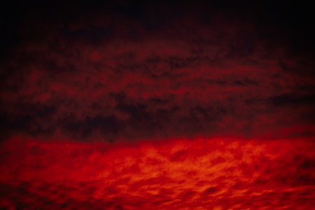 Dark red sky with clouds at sunset. Abstract background and texture.の写真素材