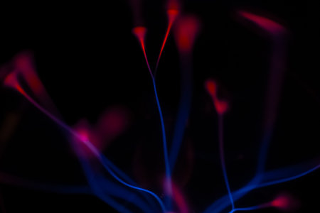Abstract background with blue and pink lines on a black background. Macro