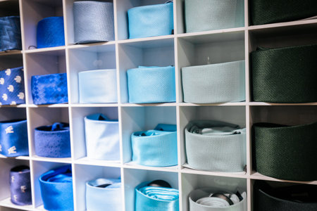 Colorful men's ties on a shelf in a shop, close up