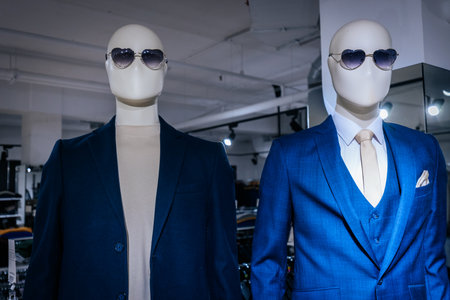 fashion mannequins in a shop window wearing blue suit and sunglassesの写真素材